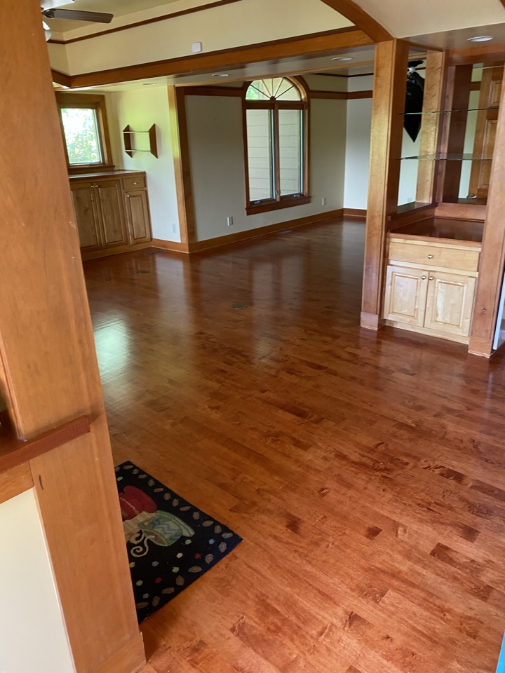 PROTEK restoration project manager reviewing this house with fresh ingredients refinished maple floors.  Home owned loves the color.   