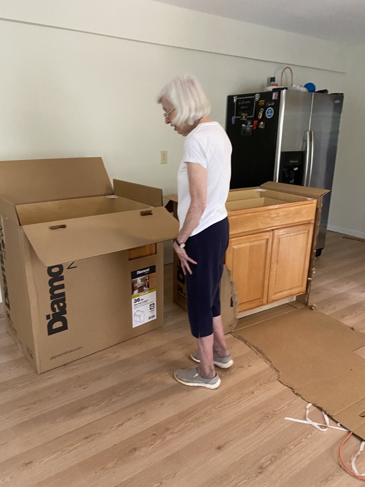 ProTek project manager assisting homeowner with decisions regarding placement of new cabinets. We tried a couple different options, but ended up with the original placement. Either way, homeowner really likes the new cabinets!