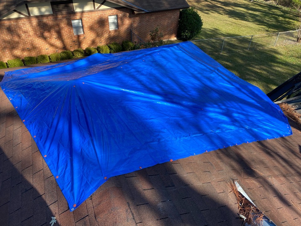 Protek assisting with roof tarp