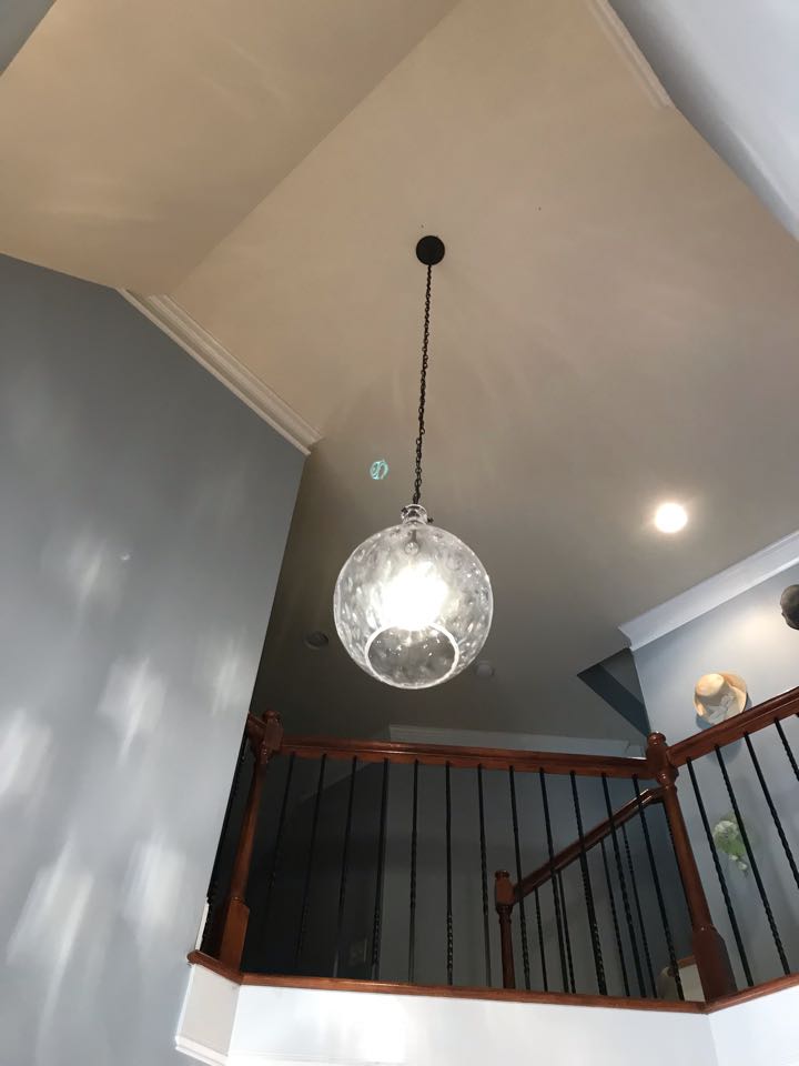 Electrician replacing lights, smoke detectors and installing whole home surge protection 