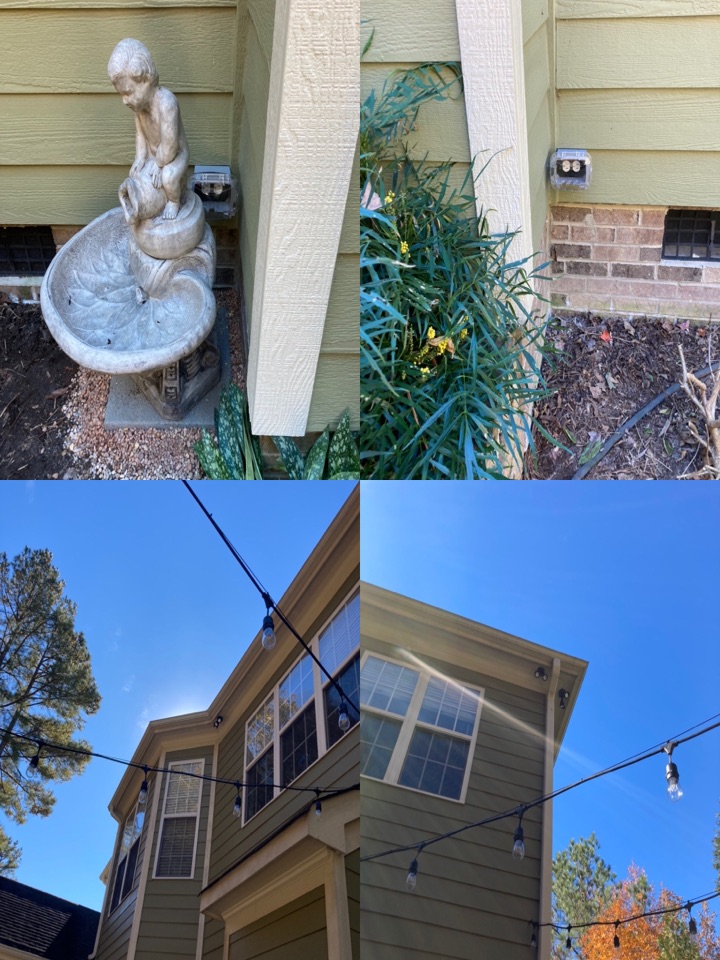 Electricians installing flood light and receptacles on the back of a home.