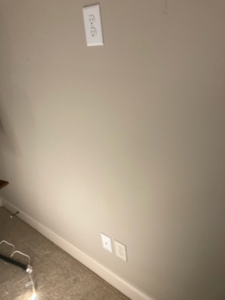 Electricians installing new data lines for two offices and also installing a new receptacle for a wall mounted TV