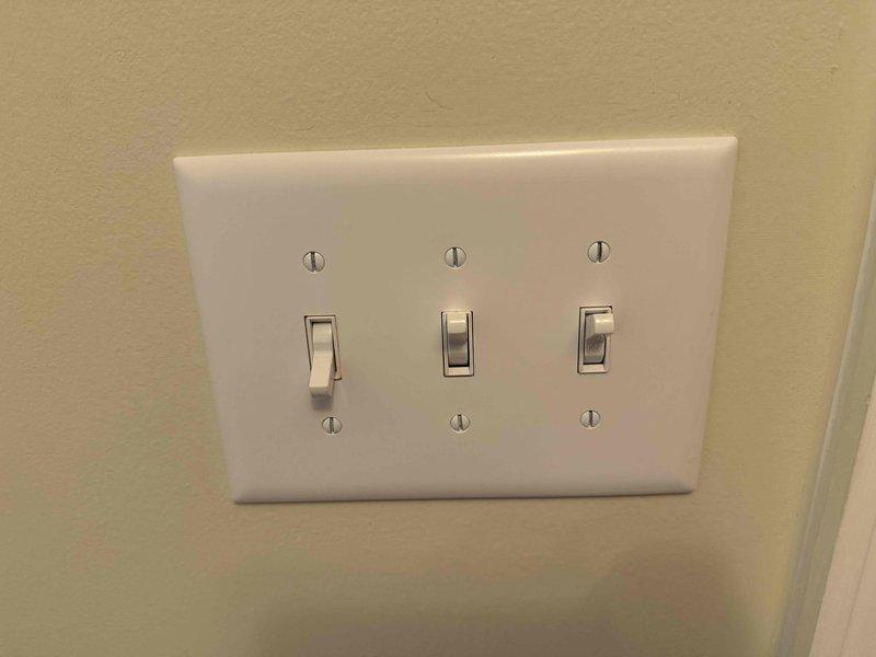 Completed installation of three GFCI outlets including two exterior locations with new weatherproof covers (Hubbell/Taymac brand), installed a standard breaker in panel, mounted two customer-supplied front porch light fixtures with new boxes, and configured a new three-gang light switch for controlling the front porch lighting system. All installations were tested and verified operational.