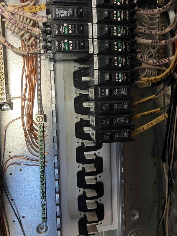 Performed 32-point electrical system evaluation on a 2015 residence. Conducted electrical panel maintenance including torque checking and connection verification of circuit breakers. Tested GFCI/shock protection outlets and Arc Fault breakers to ensure proper functionality. Visual inspection revealed an organized but aging electrical panel with properly labeled circuits and functional breakers showing green indicator lights.