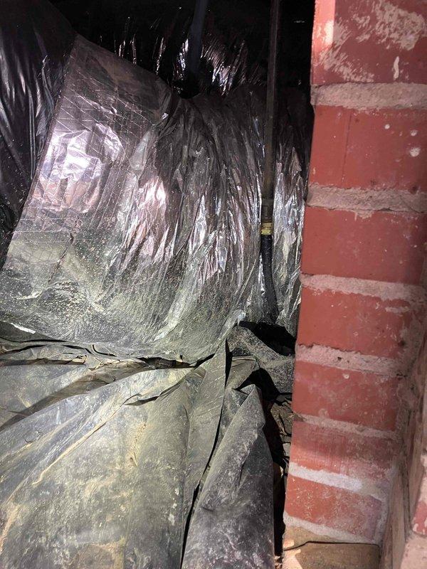 Installed customer-provided thermostat as requested. Performed system pressure testing using dual port manometer, confirming readings of 3.36 on both ports which indicates proper system balance. Inspected vapor barrier integrity in utility area where system components are housed.