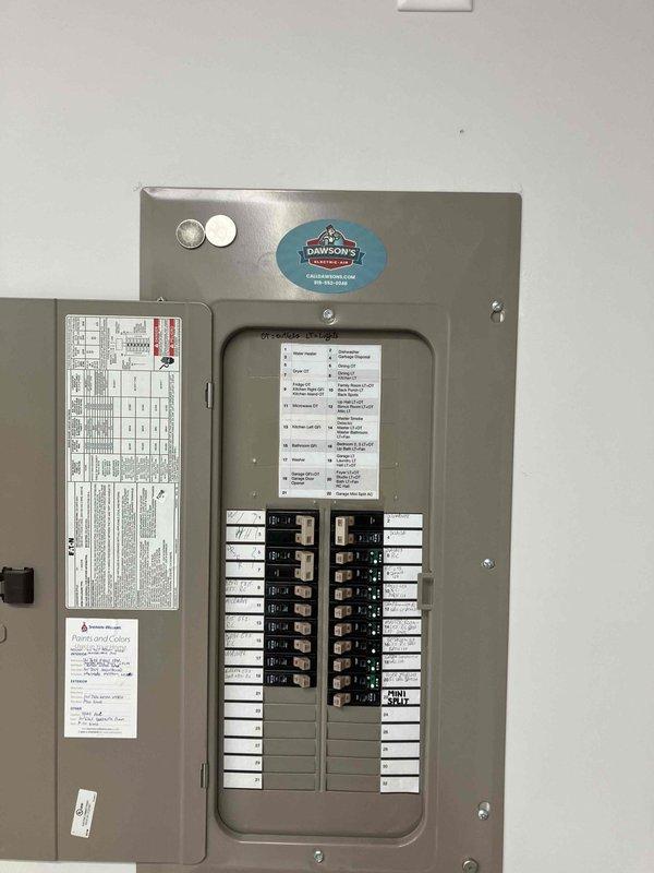 Responded to customer complaint of flickering garage lights in a 4-year-old home. Performed inspection of main electrical panel and circuit breakers. Visual examination revealed proper installation with no apparent loose connections or damaged components. Panel shows organized wiring and appears to be in normal working condition.