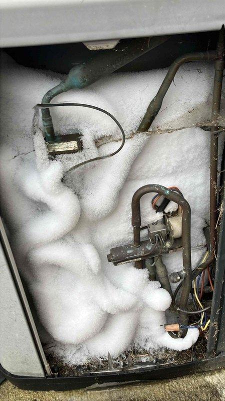 Responded to service call for frozen HVAC unit previously identified by Bryant technician. Inspection revealed excessive frost accumulation on evaporator coil and copper refrigerant lines, indicating potential refrigerant flow restriction or defrost system malfunction. Customer advised to contact their home warranty provider for further diagnosis and repair.