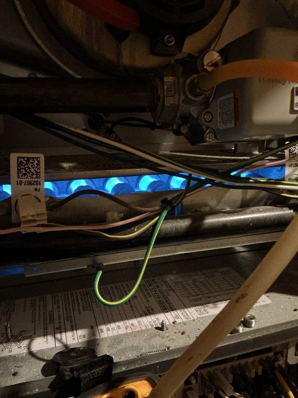 Diagnosed 9-year-old heating system with no-heat complaint. Inspection revealed damaged ignition components and flame sensor issues, evidenced by irregular blue flame pattern. Replaced faulty parts, cleaned sensor connections, and verified proper system operation with successful ignition and heating cycle.