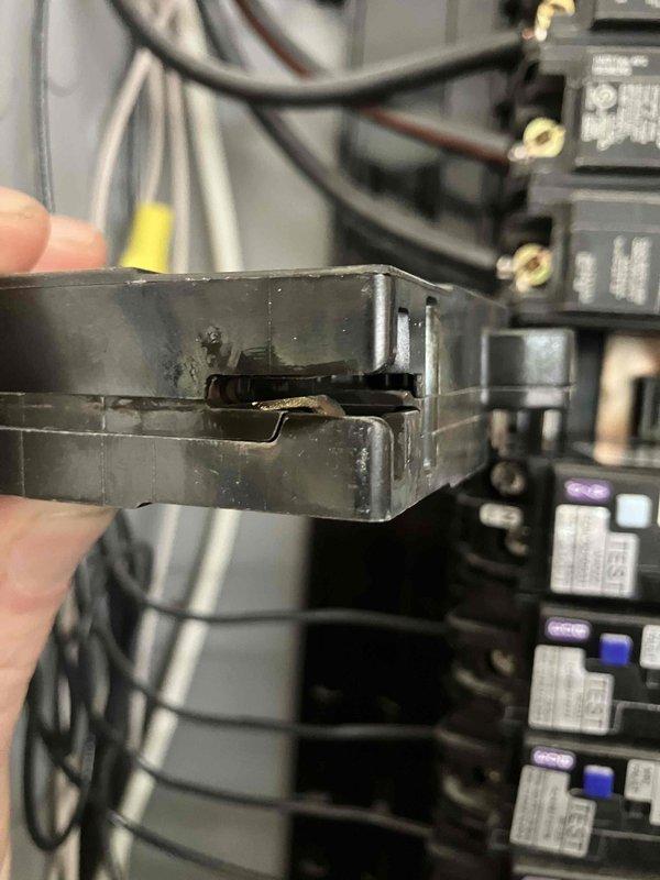 Responded to customer report of smoke odor from electrical panel. Performed inspection and identified damaged circuit breaker with visible crack. Removed the defective breaker and replaced it with new component to eliminate potential fire hazard.