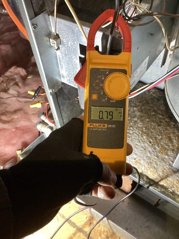 Performed comprehensive tune-up service on two aging HVAC systems (20-year and 15-year units). Conducted electrical testing with clamp meter, measuring amperage draw (0.79 amps), and inspected attic air handler installation including ductwork connections and condensate drain system. All components verified operational with no immediate service concerns identified.