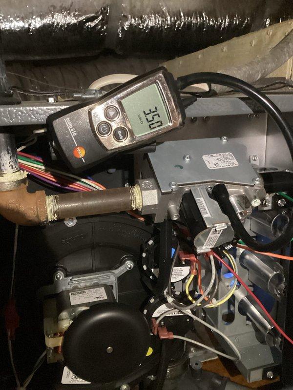 Responded to service call for non-functioning downstairs gas heating system. Diagnostic testing revealed low voltage reading of 18.5V at control board (below required 24V threshold). Further investigation showed 54°F temperature in attic space affecting system operation. Restored proper voltage by adjusting transformer connections and verified blower motor operation. System now functioning normally with proper heat output.