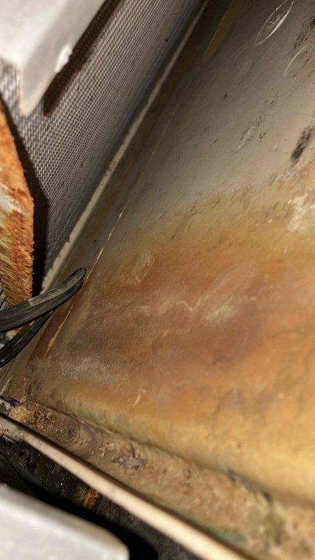 Responded to service call for frozen outdoor AC unit. Inspection revealed significant oxidation and corrosion on evaporator coil with restricted airflow. Cleaned corroded components, replaced deteriorated capacitor in electrical panel, and restored proper refrigerant levels to resolve freezing issue. System now functioning within normal parameters.