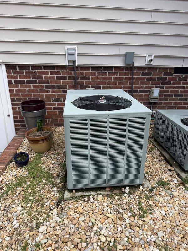 Conducted comprehensive assessment of two 20+ year-old R22 HVAC systems with visible rust damage on one coil. Documented existing units with photographs showing outdoor condensers installed on gravel bed adjacent to house with vinyl/brick exterior. Presented customer with replacement options along with repair alternatives for comparison, particularly focusing on the 19-year-old unit showing deterioration.