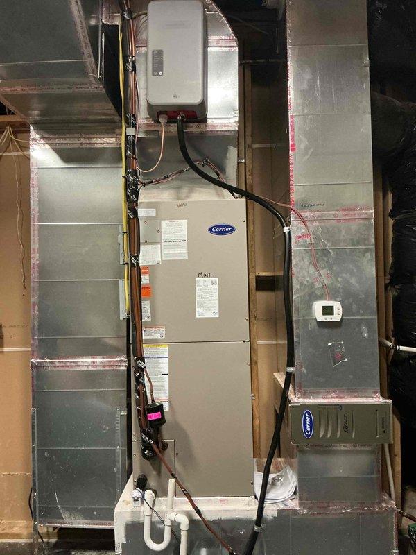 Successfully installed a Carrier steam humidifier into the supply plenum of the main floor air handler. Work included running all necessary plumbing connections and installing a dedicated electrical circuit from the main panel to the humidifier unit. System was properly connected to existing ductwork with all joints sealed according to specifications.