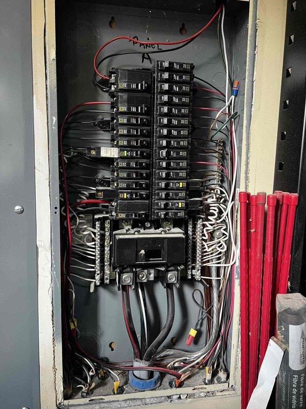 Completed 32-point electrical system evaluation on 2008 home, including panel maintenance with connection torquing, GFCI/Arc Fault breaker testing, and smoke/CO2 detector service with battery replacement. Inspected main electrical panel (Panel A) and exterior meter installation; all systems functioning properly with no issues identified.