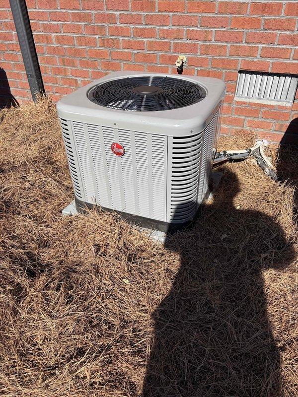 Successfully installed a Rheem outdoor condenser unit on concrete pad with proper line connections, along with interior air handler mounted on wooden platform in attic space. Complete system installation included running and securing insulated flexible ductwork throughout attic with all necessary electrical connections tested and verified for optimal operation.