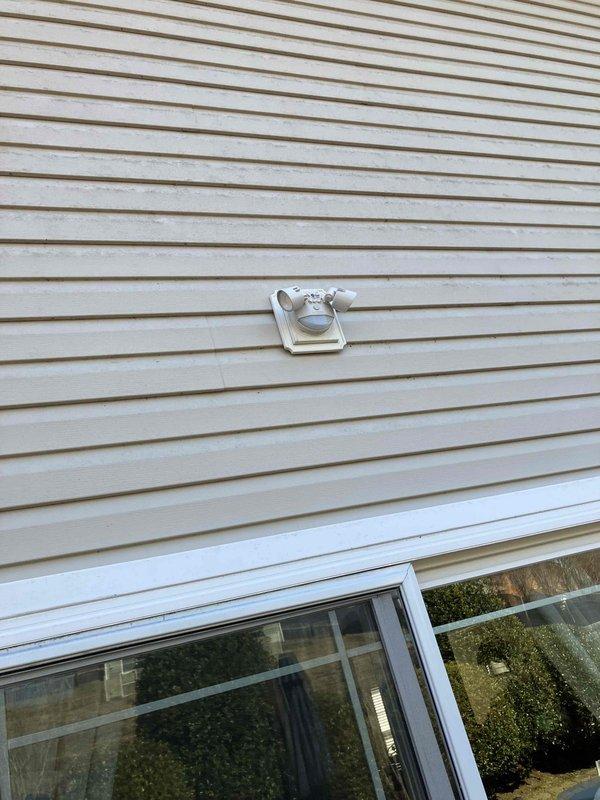 Successfully installed a motion-activated exterior light fixture above the sliding glass door in the backyard. Accessed electrical panel to establish proper circuit connection, then mounted fixture securely to the exterior siding. Tested motion sensor functionality to ensure proper operation.