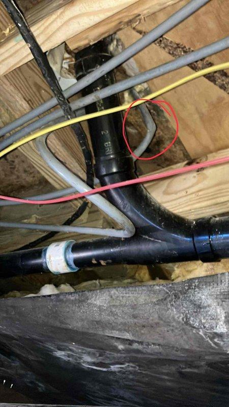 Inspected dryer vent installation and identified improper venting configuration. Documented issues with black PVC pipe connections in crawlspace, noting potential drainage concerns at T-junction connection where highlighted in documentation photos. Recommended proper venting modification to ensure code compliance and prevent potential hazards.