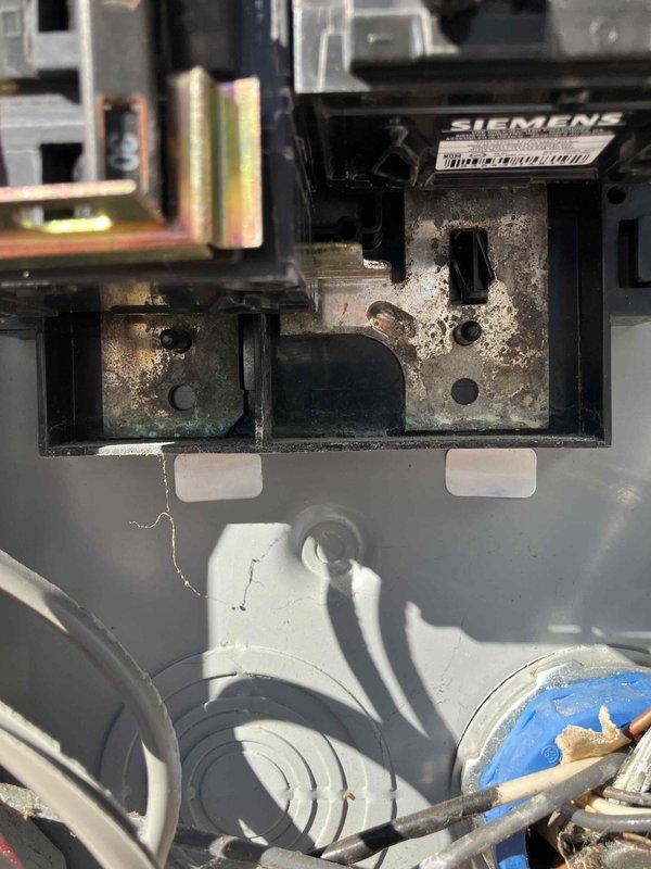 Responded to service call for front porch light replacement and flood light bulb installation. Upon inspection, discovered significant corrosion on electrical components in the main panel, particularly around Siemens device mounting points. Replaced chandelier fixture on front porch, replaced flood light bulb, and documented electrical panel condition with labeled circuit breakers for future reference.