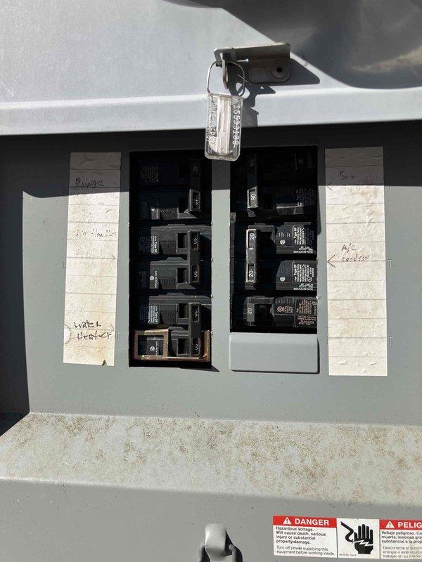 Responded to service call for front porch light replacement and flood light bulb installation. Upon inspection, discovered significant corrosion on electrical components in the main panel, particularly around Siemens device mounting points. Replaced chandelier fixture on front porch, replaced flood light bulb, and documented electrical panel condition with labeled circuit breakers for future reference.