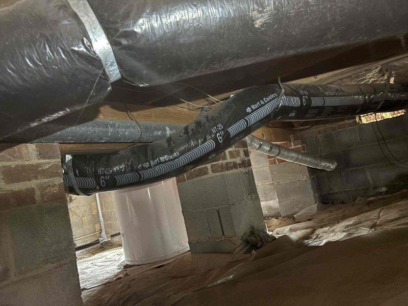 Conducted inspection of existing dryer ductwork in crawlspace area. Evaluated condition of insulated flexible ducting, which showed signs of wear but remains functionally installed. Documented electrical panel configuration and surrounding utility infrastructure for reference during potential ductwork replacement.