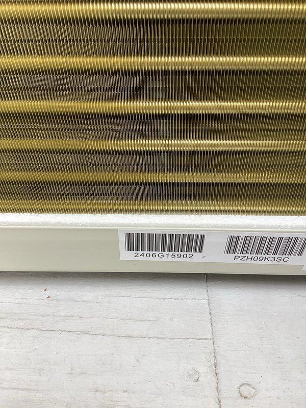 Completed PTAC unit installation with customer-provided equipment. Inspected electrical sub-panel to ensure proper circuit configuration and verified heat exchanger/condenser coil integrity (unit serial #2406G15902, model #PZH09K3SC) prior to final installation and testing.