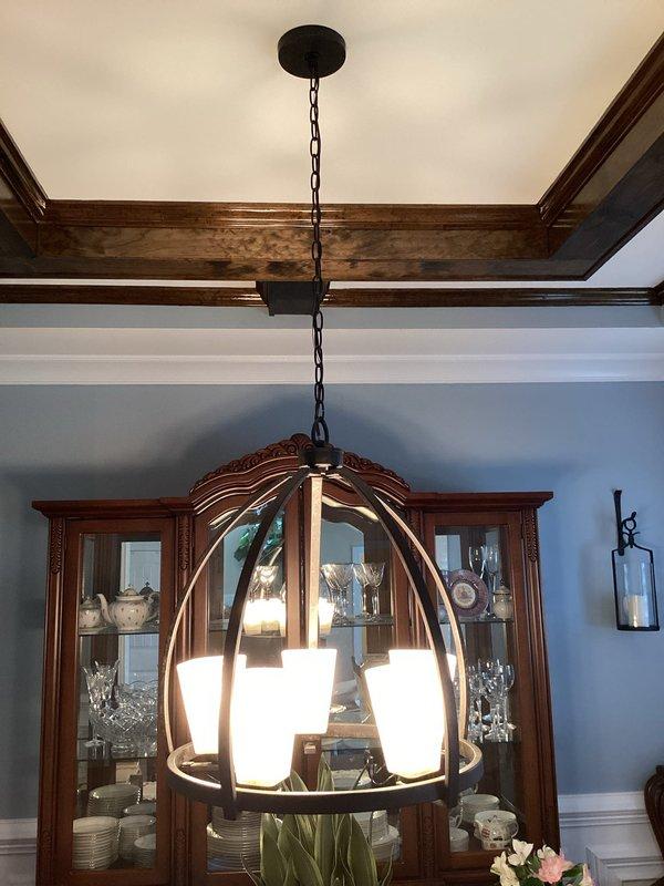 Successfully installed multiple light fixtures throughout residence, including a semi-flush mount ceiling light with drum-style shade in hallway/entryway and an elegant pendant fixture with circular metal frame and glass shades in dining room. All installations were completed according to specifications, with proper electrical connections and secure mounting.