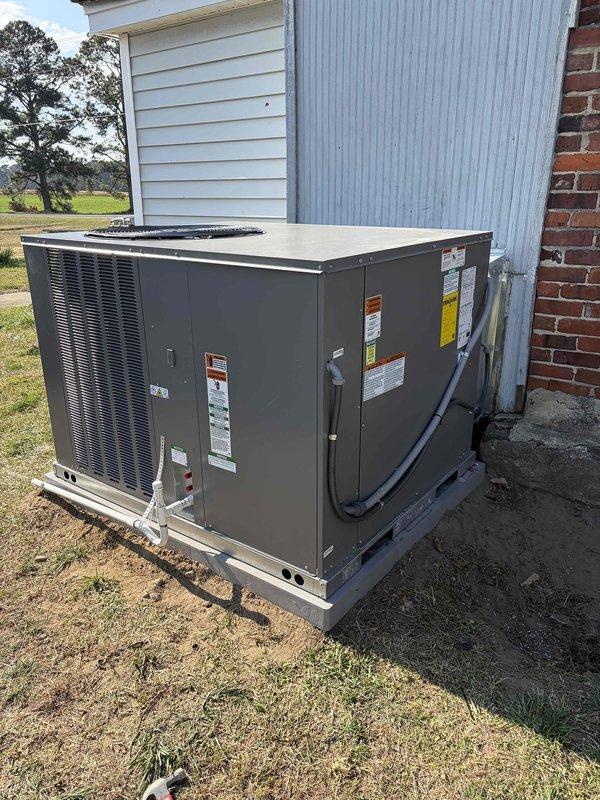 Completed removal of customer's existing pack unit as requested and successfully installed new HVAC system. New outdoor unit was properly positioned on concrete pad with all electrical connections and refrigerant lines securely attached to the building. Installed and programmed new Honeywell Home digital thermostat, confirming system functionality with temperature reading at 82 degrees.