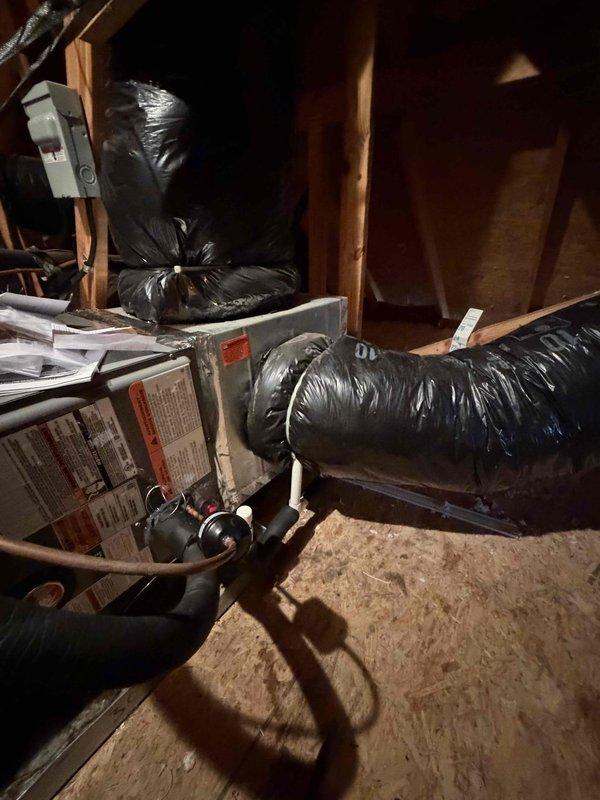 Completed installation of a new furnace/air handler unit in utility space with proper connections to existing ductwork. Installed black insulated flexible ducting throughout the space with appropriate routing through structural framing. System was properly secured with all necessary components connected and tested for operation.