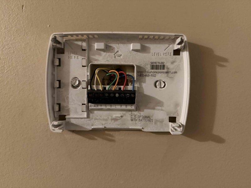 # HVAC Sales Call Summary

Conducted sales consultation for dual-system residential HVAC replacement. Customer requested estimate for upstairs unit replacement along with repair options for comparison purposes. Both systems are aging units (17 and 16 years old). Documented existing thermostat wiring configurations for both zones, photographing terminal connections showing standard color-coded wiring (R, W, Y, G, C terminals) to ensure proper compatibility assessment for replacement equipment recommendations.
