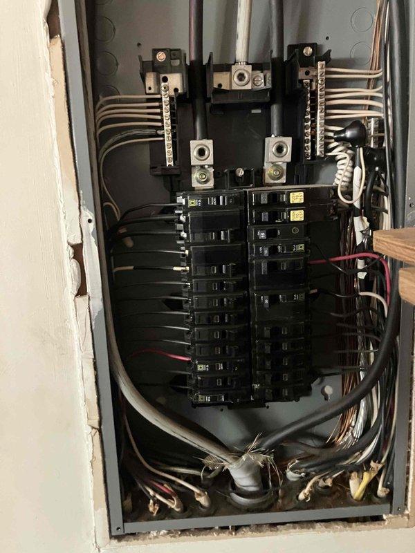 # Service Call Summary

Responded to electrical emergency where homeowner experienced blue arcing when plugging in device in office, resulting in multiple outlets becoming inoperative on the circuit. Breaker had been shut off by customer to prevent further damage.

## Work Performed

Conducted comprehensive electrical inspection of affected office circuit and main electrical panel. Examined panel interior and identified circuit breakers serving the compromised office area. Documented existing electrical panel configuration showing proper wire connections to breakers and bus bars. Inspected main distribution panel with dual rows of circuit breakers, noting copper conduit entry points and wire routing throughout the system. Evaluated all visible electrical connections, terminals, and breaker conditions for signs of damage, overheating, or deterioration related to the arcing event. Photographed panel interior showing breaker arrangement, wire connections, and overall panel condition for s