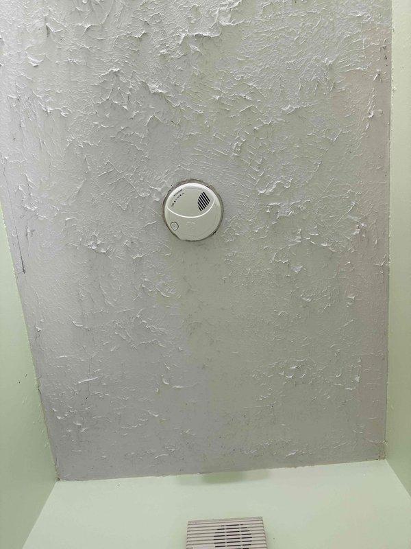 Installed GFCI receptacles in the master bathroom, replaced existing GFCI in hall bathroom, installed GFCI protection for kitchen countertop outlets, and installed GFCI for washing machine circuit. Provided and installed three wireless interconnected smoke detectors in bedrooms and one hardwired smoke/CO combination detector in the hallway with wireless communication capability to integrate with bedroom units. Verified proper operation of all GFCI devices using outlet tester, confirming correct wiring and ground fault protection functionality.