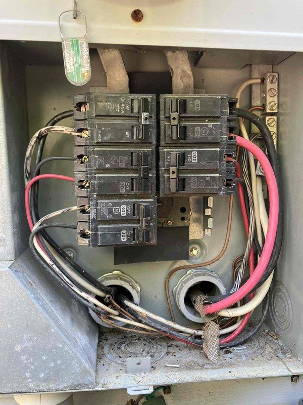 Performed comprehensive whole-home electrical safety evaluation on 2009 residence experiencing nuisance tripping on breakers #8 and #18 under simultaneous load conditions. Conducted thorough inspection of main electrical panel, examining all circuit breakers, wire connections, and grounding systems for signs of overloading, loose connections, or component failure. Documented panel interior conditions including wire routing, breaker arrangement, and overall system integrity through photographic evidence. Evaluated load distribution across circuits and identified potential causes of repetitive tripping on affected breakers, which may indicate undersized circuits, deteriorating breaker contacts, or excessive connected loads exceeding circuit capacity.