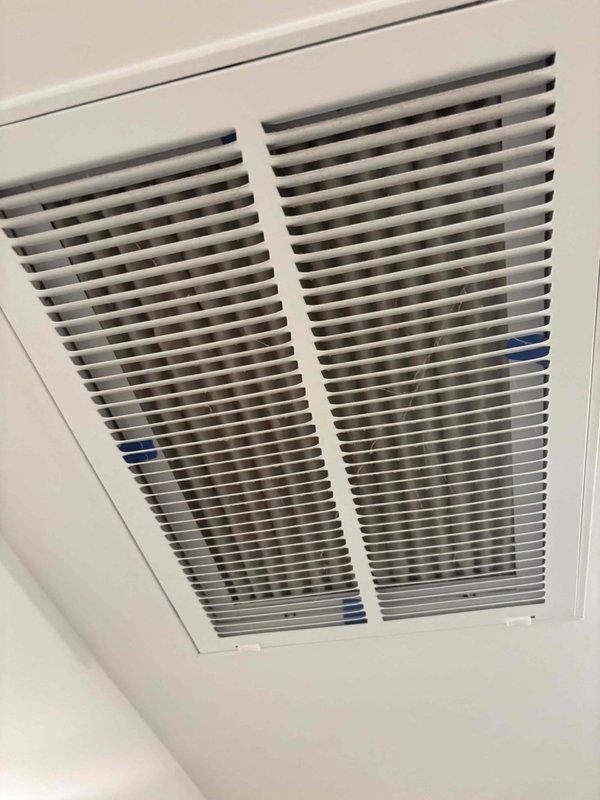 Responded to no cooling call on 2-zone system installed in 2016. Upon arrival, found system running but not providing adequate cooling - minimal cool air output with home remaining excessively warm. Inspected air return grille and accessed control panel to evaluate electrical components and wiring connections; documented existing conditions for diagnostic purposes.