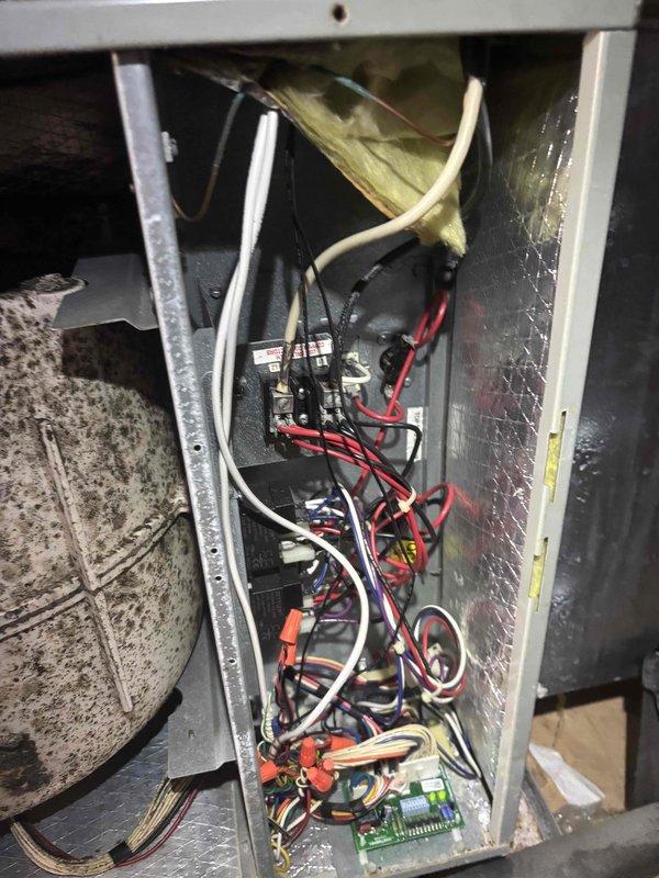 Responded to no cooling call on 2-zone system installed in 2016. Upon arrival, found system running but not providing adequate cooling - minimal cool air output with home remaining excessively warm. Inspected air return grille and accessed control panel to evaluate electrical components and wiring connections; documented existing conditions for diagnostic purposes.