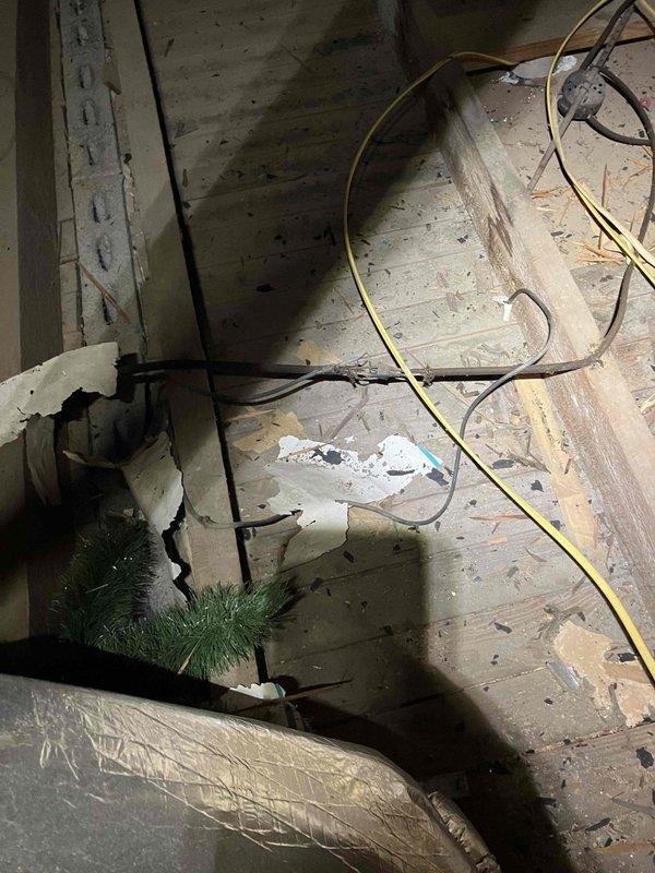Responded to electrical safety concern at 1948 residential property regarding potential fire hazard in attic wiring. Performed thorough inspection of attic space and existing electrical panel assembly, documenting conditions with photographs. Assessed exposed wiring running across attic floor, deteriorated insulation near electrical components, and overall state of electrical distribution system including industrial-grade contactor, circuit breakers, and copper cable connections to determine necessary rewiring scope and safety recommendations.