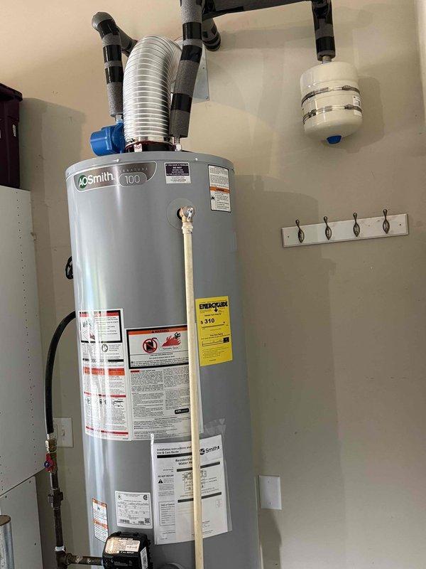 Responded to service call regarding exposed live electrical wire at newly installed A.O. Smith ProMax water heater located in garage. Upon arrival, verified electrical hazard and safely de-energized circuit at main panel. Removed abandoned energized conductor that was left exposed during water heater installation, properly capped wire ends, and secured within junction box per NEC standards. Verified all electrical connections to water heater were properly terminated and grounded, restored power, and confirmed safe operation of unit.