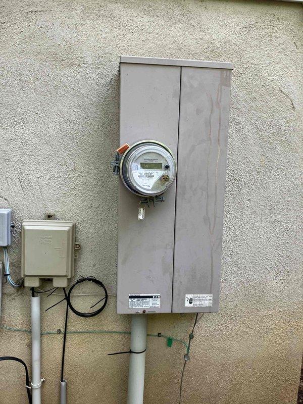 Installed a dedicated 240-volt circuit for electric vehicle charging capability in the garage of a 1999 home. Ran new wiring from the exterior main electrical panel through the wall to a new outlet installation point, utilizing appropriate gauge conductors for EV charging loads. Mounted and wired a NEMA outlet in a metal electrical box within the garage, ensuring proper grounding and secure connections for safe high-amperage operation.