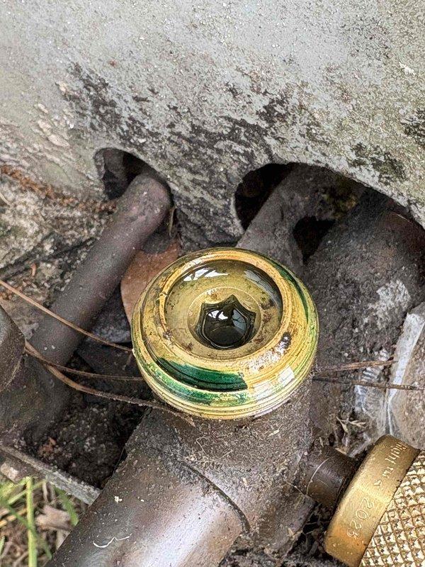 # HVAC Service Completed

Responded to no cooling complaint on 5-year-old residential air conditioning system. Upon arrival, confirmed unit was running with airflow present but no cold air output. Conducted comprehensive system inspection and diagnostics.

Discovered severely corroded outdoor unit disconnect and deteriorated electrical connections at condensing unit. Extensive rust and oxidation present on line set connections and outdoor electrical components, indicating prolonged moisture exposure and age-related deterioration. Indoor unit evaporator coil area showed heavy dust and debris accumulation on electrical terminals and mounting brackets, compromising system performance and creating potential safety hazards.

Documented equipment condition with photographic evidence showing advanced corrosion on brass fittings, rusted piping, deteriorated concrete pad with water staining, and contaminated indoor components with significant lint and insulation fiber buildup. Electrical connec