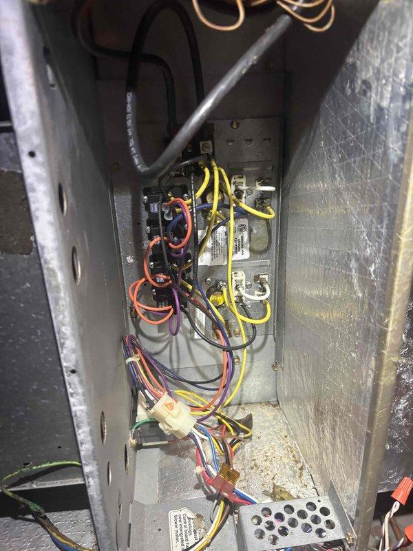 Responded to no cooling complaint for downstairs zone on multi-zone system. Inspected attic-mounted air handler and zone control panel, documenting damaged flexible ductwork with torn outer vapor barrier and exposed insulation. Verified zone damper wiring connections at control board showing proper color-coded wire terminations to multiple thermostats. Identified compromised ductwork as likely cause of reduced airflow and inadequate cooling to downstairs zone.