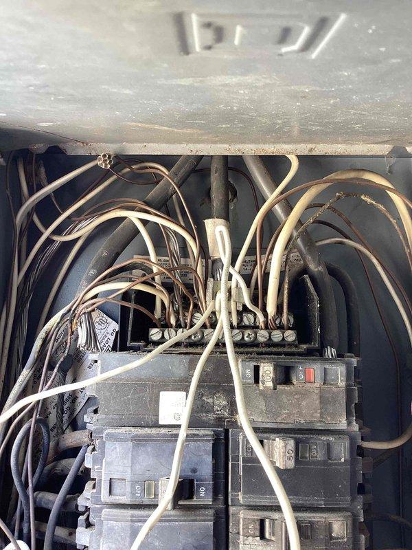 Responded to complete loss of power at 1962 residence where main breaker had tripped and was running hot to the touch. Upon inspection, found outdated electrical service panel with signs of age, dust accumulation, and disorganized wiring throughout the enclosure. Main breaker exhibited overheating due to deteriorated connections and excessive resistance at terminal points. Determined that the aging panel components and inadequate wire terminations were causing the thermal event. Reset main breaker after allowing cooling period and verified proper voltage at meter base and distribution panel. Inspected all branch circuit breakers for similar thermal stress and tested connections. Advised that the entire service panel requires replacement due to age-related deterioration, outdated components, and safety concerns related to the overheating main breaker. Restored temporary power to residence but strongly recommended immediate panel upgrade to prevent recurring outages and potential fire ha