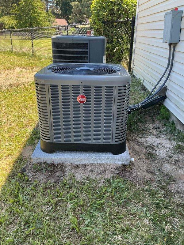 # HVAC System Installation

Successfully completed a full HVAC system installation consisting of a Rheem outdoor condensing unit and indoor air handler. The outdoor unit was positioned on a concrete pad on the side of the residence with proper clearances maintained. Electrical disconnect box was mounted to exterior wall with conduit run providing power to the unit. Inside the garage, installed a vertical air handler unit with appropriate ductwork connections including flexible supply ducting. All electrical wiring was secured and run according to code requirements. System was tested for proper operation, refrigerant levels verified, and all safety labels and manufacturer specifications confirmed visible and intact. Installation meets industry standards and manufacturer requirements for optimal system performance.