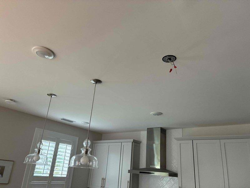 Successfully installed three homeowner-provided pendant light fixtures over the kitchen island, mounting each unit to the ceiling with proper electrical connections and ensuring secure attachment of the decorative glass shades. All fixtures were tested for proper operation, with switches functioning correctly and illumination confirmed across all three pendant lights.