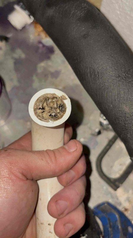 Responded to no cool air complaint on 3-year-old residential air conditioning system. Upon inspection, discovered severely clogged condensate drain line preventing proper system operation. Cleared heavy sediment and debris buildup from PVC drain line to restore proper drainage. Verified system electrical readings at outdoor unit showing 524.4 volts, confirming adequate power supply to equipment. Restored cooling operation and ensured condensate removal system functioning properly to prevent future shutdowns.