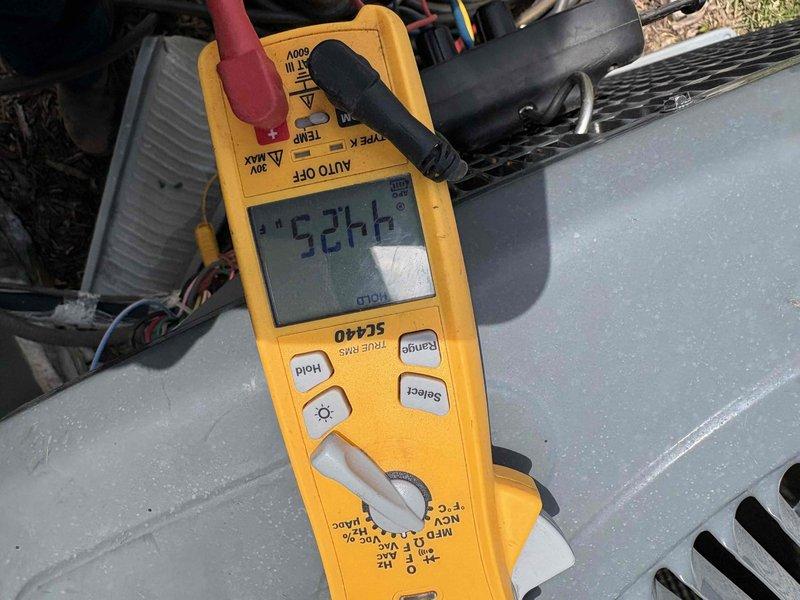 Responded to no cool air complaint on 3-year-old residential air conditioning system. Upon inspection, discovered severely clogged condensate drain line preventing proper system operation. Cleared heavy sediment and debris buildup from PVC drain line to restore proper drainage. Verified system electrical readings at outdoor unit showing 524.4 volts, confirming adequate power supply to equipment. Restored cooling operation and ensured condensate removal system functioning properly to prevent future shutdowns.