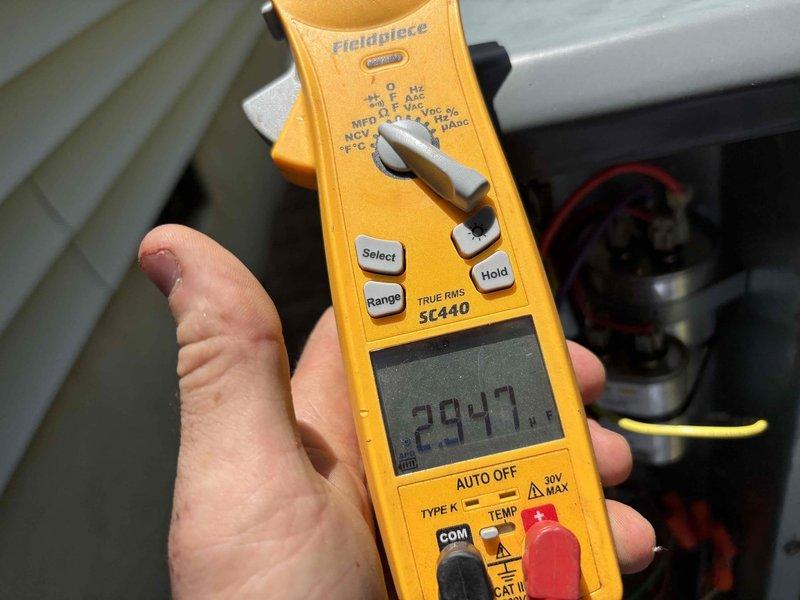 Responded to no cooling call on 8-year-old single system. Upon arrival, performed diagnostic testing of outdoor unit using digital multimeter. Measured capacitance reading of 400.9 MFD and amperage draw of 294.7 on compressor circuit, indicating potential electrical issues affecting system operation. Customer also reported inadequate airflow to guest bedroom prior to complete system failure, suggesting possible secondary issue with ductwork or zoning that will require further evaluation once primary cooling issue is resolved.