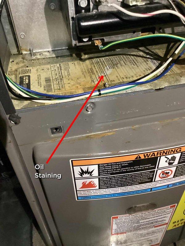 Responded to no-cooling call with both upstairs and downstairs thermostats displaying blank screens. Upon arrival, confirmed total loss of power to HVAC system despite homeowner's attempts to reset breakers. Conducted systematic diagnostic of 2016 unit and discovered complete electrical failure at furnace. Inspection revealed oil staining on furnace cabinet indicating potential transformer failure or electrical component breakdown. Additionally noted outdoor coil exhibited significant contamination with dirt and debris buildup restricting airflow through condenser fins. Documented conditions with photographs showing oil leakage patterns and dirty coil requiring cleaning for optimal system performance once power issue resolved.