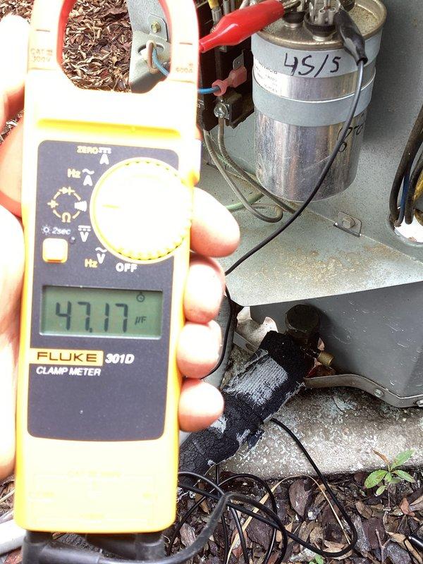 Responded to no airflow complaint on 11-year-old system. Found outdoor unit running but indoor blower not operating. Diagnosed failed run capacitor on blower motor using clamp meter, measuring 47.17 µF on capacitor rated for 45 µF, indicating capacitor degradation. Inspected HZ311 zone control module and verified proper signaling to equipment. Replaced defective run capacitor, restored system operation, and confirmed proper airflow throughout home.