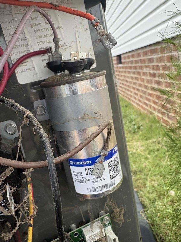 Responded to no-cool call on 2021 system following power outage from storm. Upon arrival, found outdoor unit receiving power but condenser fan motor not operating. Diagnosed failed dual-run capacitor showing visible swelling and discoloration on metallic casing. Removed defective capacitor and installed new replacement capacitor with proper microfarad rating. Verified all electrical connections secure, tested system operation, and confirmed condenser fan motor and compressor now running properly with normal amp draw. System restored to full cooling operation.