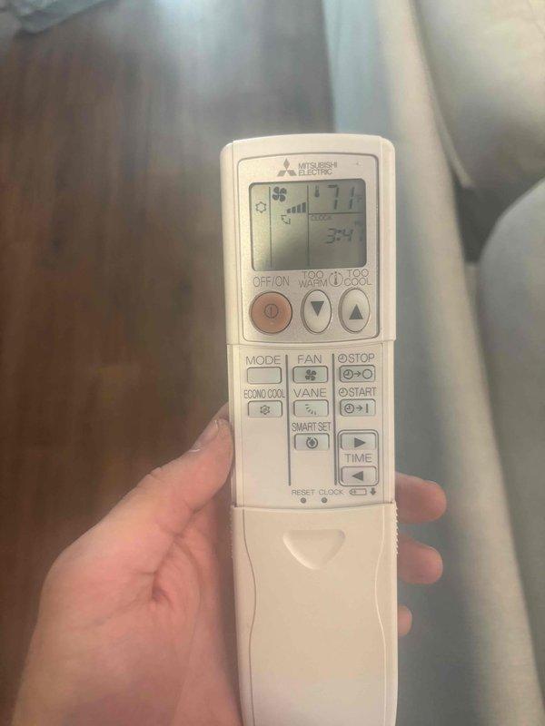Responded to no cooling complaint on Mitsubishi Electric mini split system blowing ambient air only. Upon arrival, inspected indoor unit and verified remote control settings and operation. Examined outdoor unit heat exchanger coil and electrical connections, noting condition of components and wiring terminals. System evaluated and documented with photos of remote control display and outdoor unit coil assembly with electrical housing for further diagnostic assessment.